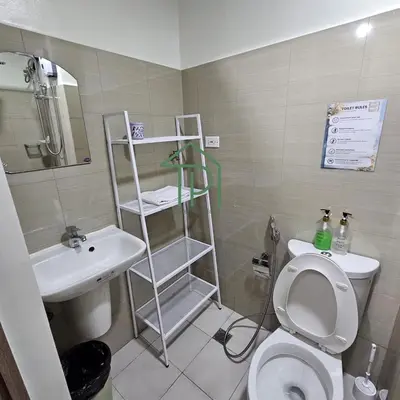 a small bathroom with a toilet and a sink at 1BR Pool View Balcony Near MOA Shore 2 Tower 1 in Manila