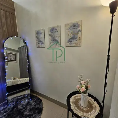 a dressing room with a mirror and a table with flowers at 1BR Pool View Balcony Near MOA Shore 2 Tower 1 in Manila