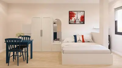 a living room with a couch and a table at Llanes A Studio Apartment in Manila