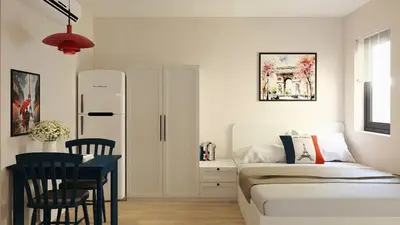 a bedroom with a bed and a table and a desk at Llanes A Studio Apartment in Manila