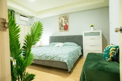 a bedroom with a bed and a plant at Nature Serenity Suites 2BR Makati in Manila