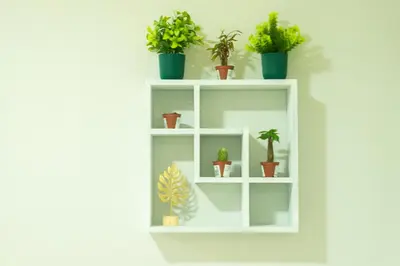 a white shelf with potted plants on it at Nature Serenity Suites 2BR Makati in Manila