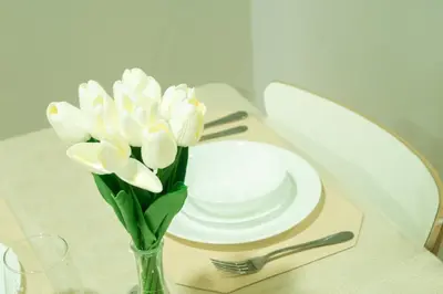 a vase filled with white flowers sitting on a table at Nature Serenity Suites 2BR Makati in Manila