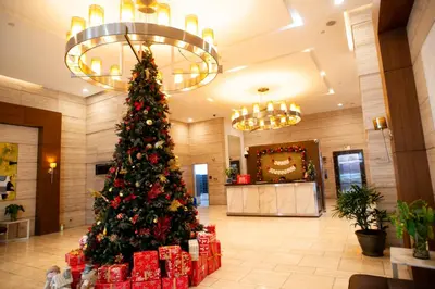 a christmas tree in a lobby with presents at Nature Serenity Suites 2BR Makati in Manila