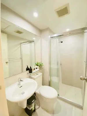 a bathroom with a toilet and a sink and a shower at Azure Rio East 221 in Manila