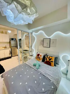 a bedroom with a large bed with a ceiling at Azure Rio East 221 in Manila