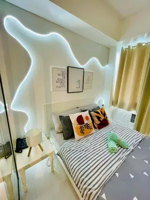 a small bedroom with a bed with a striped mattress at Azure Rio East 221 in Manila