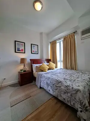 a bedroom with a large bed and a window at Cozy Hotel-Style 1 Bedroom Unit 5L at Eastbay Residences by Rockwell in Manila