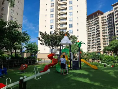 a group of children playing on a playground at Cozy Hotel-Style 1 Bedroom Unit 5L at Eastbay Residences by Rockwell in Manila