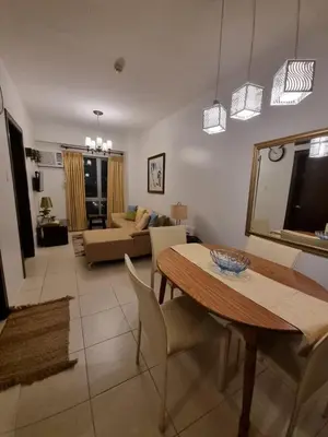 a living room with a table and a couch at Cozy Hotel-Style 1 Bedroom Unit 5L at Eastbay Residences by Rockwell in Manila