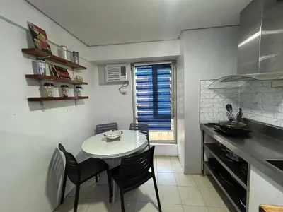a kitchen with a table and chairs in a kitchen at Ports Avida San Lazaro Condo in Manila