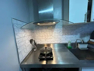 a kitchen with a counter top with a stove at Ports Avida San Lazaro Condo in Manila