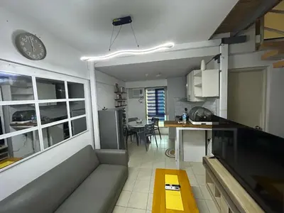 a living room and kitchen with a couch and a table at Ports Avida San Lazaro Condo in Manila