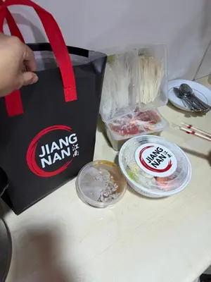 a bag sitting on top of a table with food at Ports Avida San Lazaro Condo in Manila