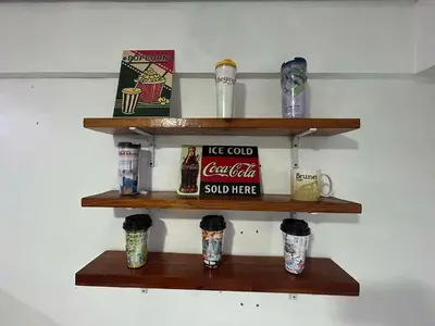 a shelf on a wall with drinks and cups at Ports Avida San Lazaro Condo in Manila