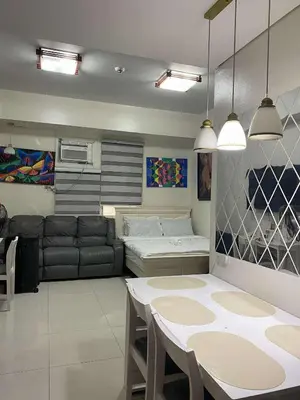 a living room with a table and a couch at Vienna Condotel in Manila