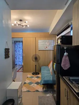 a small room with a kitchen with a refrigerator at Shore 2 Residences in Manila