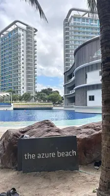 a sign in front of a swimming pool with buildings at The Session Azure in Manila