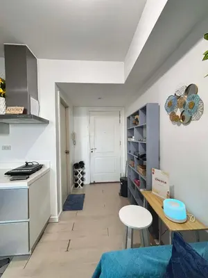 a kitchen with a counter and a table in a room at The Session Azure in Manila