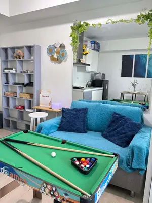 a living room with a pool table and a couch at The Session Azure in Manila