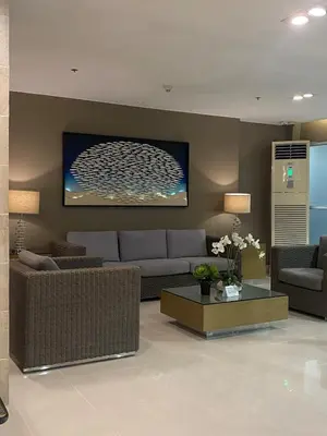 a living room with a couch and a table at Apartment in MOA Pasay City Homey Luxury in Manila