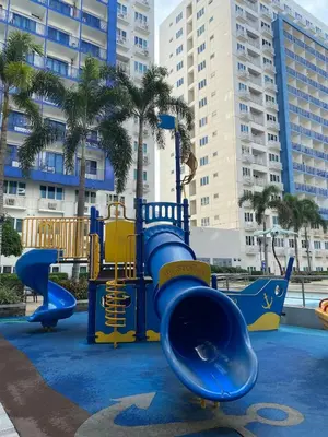 a playground with blue and yellow equipment in a city at Apartment in MOA Pasay City Homey Luxury in Manila