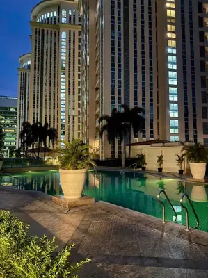 a swimming pool in front of some tall buildings at Venice Luxe Cozy 1 BedRoom, Pool, Netflix, Kitchen, Canal Mall Access in Manila