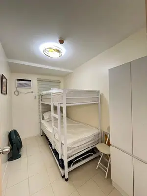 a room with two bunk beds and a table at 2BR DECA HOME Pasig City in Manila