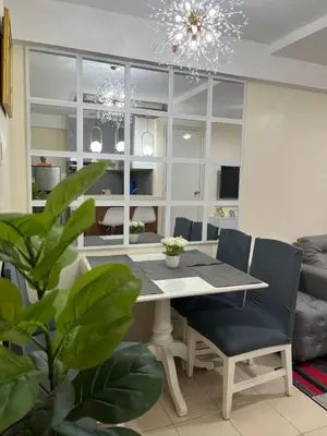 a dining room with a table and chairs at 2BR DECA HOME Pasig City in Manila