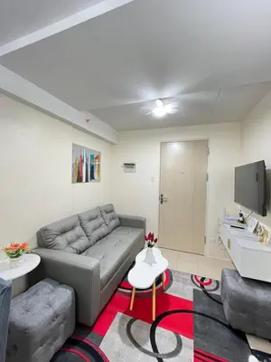 a living room with a couch and a tv at 2BR DECA HOME Pasig City in Manila