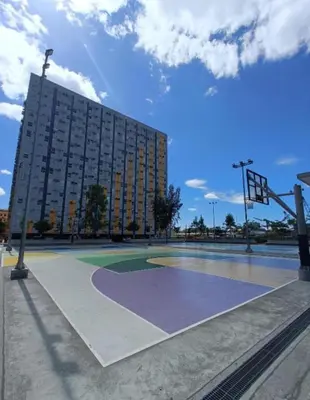 a basketball court in front of a large building at 2BR DECA HOME Pasig City in Manila