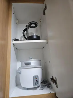 a pot sitting on a shelf in a cabinet at Shell Low Floor Amenity Pool View with Balcony MOA Shell004 in Manila