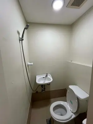 a small bathroom with a toilet and a sink at 2 Bedroom at The infinity Condominium at BGC in Manila