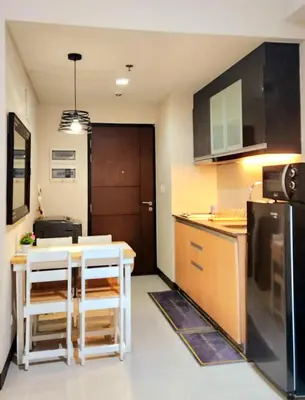 a small kitchen with a counter and a table at House of B&Y 101 newport blvd across treminal3 in Manila