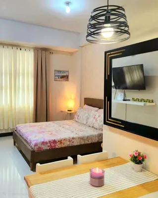 a bedroom with a bed and a mirror and a table at House of B&Y 101 newport blvd across treminal3 in Manila