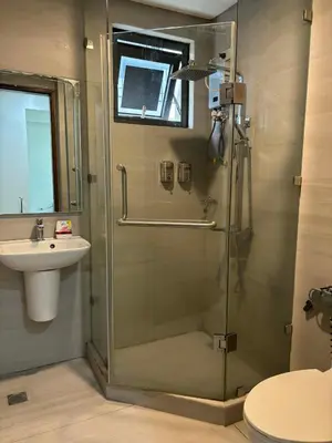 a bathroom with a shower and a sink at Sunnyplace Residences 2 BR Near NAIA Airport in Manila