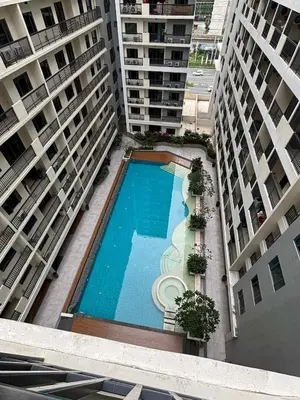 an overhead view of a swimming pool between two buildings at Sunnyplace Residences 2 BR Near NAIA Airport in Manila