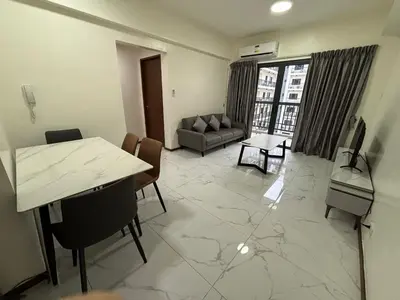 a living room with a couch and a table at Sunnyplace Residences 2 BR Near NAIA Airport in Manila