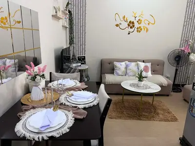 a living room with a table and a couch at Casa Feliz Staycation in Manila