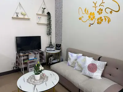 a living room with a couch and a table at Casa Feliz Staycation in Manila