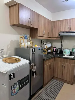 a kitchen with a refrigerator and a dishwasher at Casa Feliz Staycation in Manila