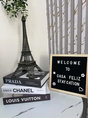 a stack of books with the eiffel tower on top at Casa Feliz Staycation in Manila