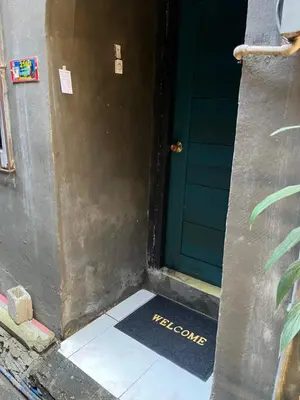 a door with a welcome mat in front of it at Liza residence in Manila