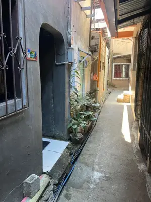 an alley with a door and plants in a building at Liza residence in Manila