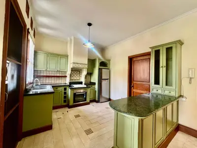 a kitchen with green cabinets and a counter top at Happy Place Antipolo in Antipolo