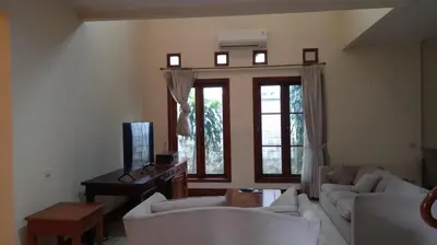a living room with two white couches and a television at Happy Place Antipolo in Antipolo