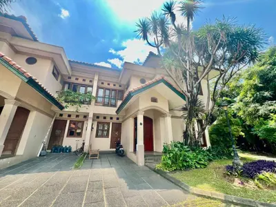 a house with a palm tree in front of it at Happy Place Antipolo in Antipolo