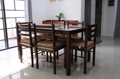 a dining room table and chairs with a plant on it at Idesia Dasmarinas NEW 3BR home with wifi & parking in Dasmariñas