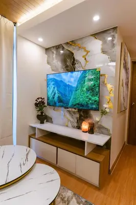 a living room with a flat screen tv on a wall at AZ Sweet home 2BR A Venue Residences Poblacion Makati in Manila