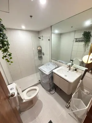 a bathroom with a toilet and a sink at AZ Sweet home 2BR A Venue Residences Poblacion Makati in Manila